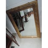 A 19th century gilt plaster frame rectangular wall mirror having swivel decoration, approx
