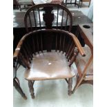 A 19th century yew and elm Windsor armchair having splat and spindle back, with solid seat and