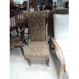 A Victorian mahogany frame prieu dieu prayer chair having later moquette upholstery and turned legs