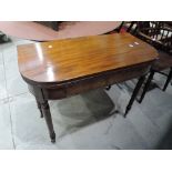 An early 19th century mahogany tea table having fold over D top on turned gate legs, width approx.