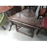 An early 20th Century occasional table having drop leaf circular triform top having extensive