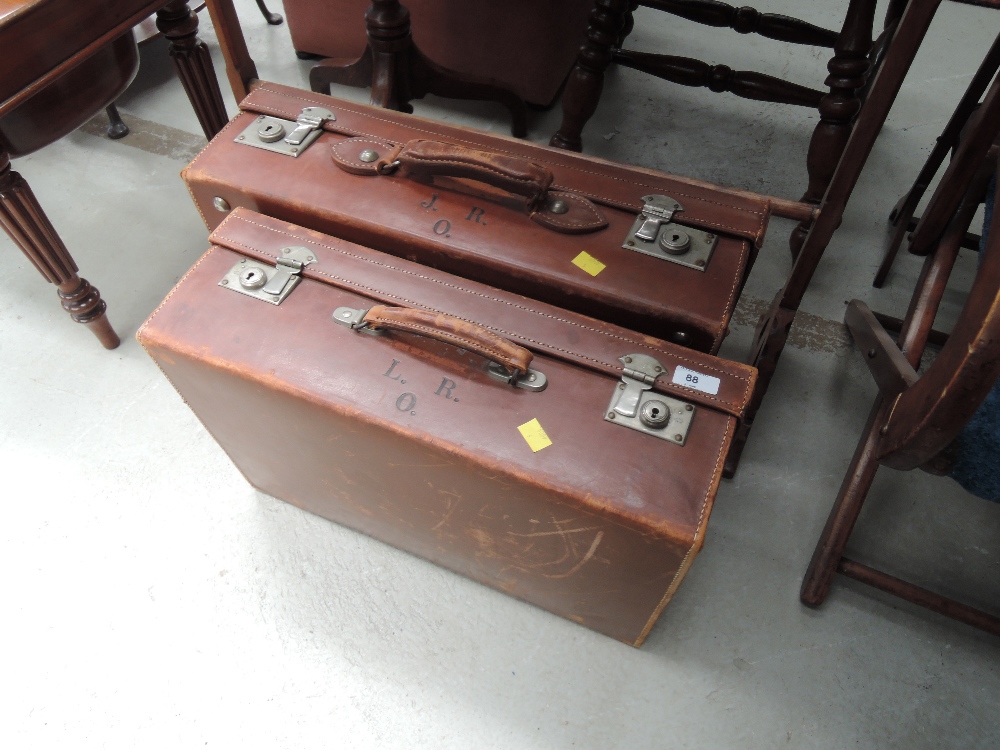 Two vintage leather suitcases of traditional style