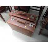 Two vintage leather suitcases of traditional style