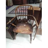 An early 19th Century beech and elm Windsor armchair having hoop and stick back with solid seat