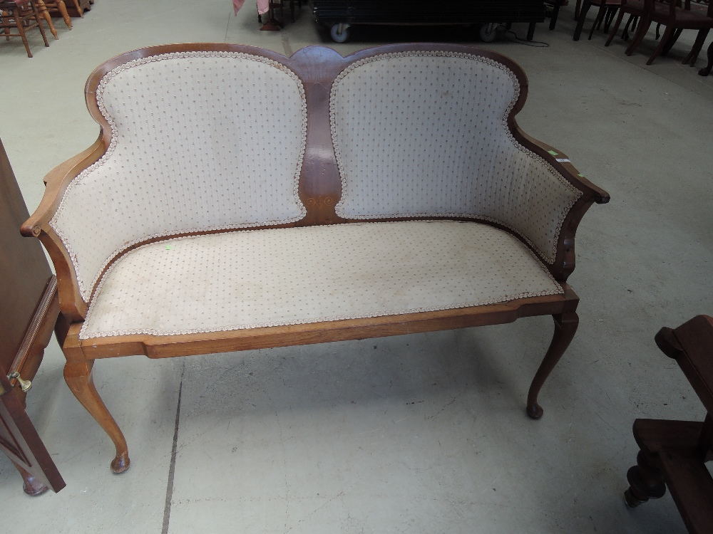 An Edwardian mahogany frame salon settee having double scroll back with line web inlay, and later