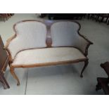 An Edwardian mahogany frame salon settee having double scroll back with line web inlay, and later