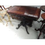 A 20th Century stained frame card table in the William IV style having foliate swivel top on