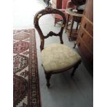 A Victorian mahogany salon chair of scroll balloon back design having applique decoration and