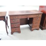 A 19th century mahogany desk having narrow rectangular top on pedestal supports and bracket feet,