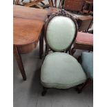 A Victorian spoon back chair having stained frame and later pale green upholstery in knurl