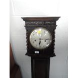A 1920's dark oak granddaughter clock having circular silvered dial and barley twist detail with 1/2
