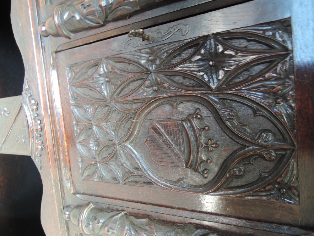 A late 19th century oak credence cupboard having extensive medieval style carved decoration with - Image 6 of 6