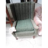 An early 20th Century stained frame Parker Knoll patent armchair having green moquette upholstery,