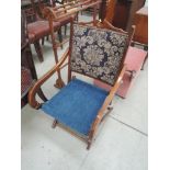 A 19th Century mahogany frame folding chair having later carpet panels