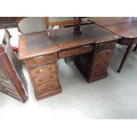 A Victorian burr walnut desk having inset skiver top with central frieze drawer and pedestal