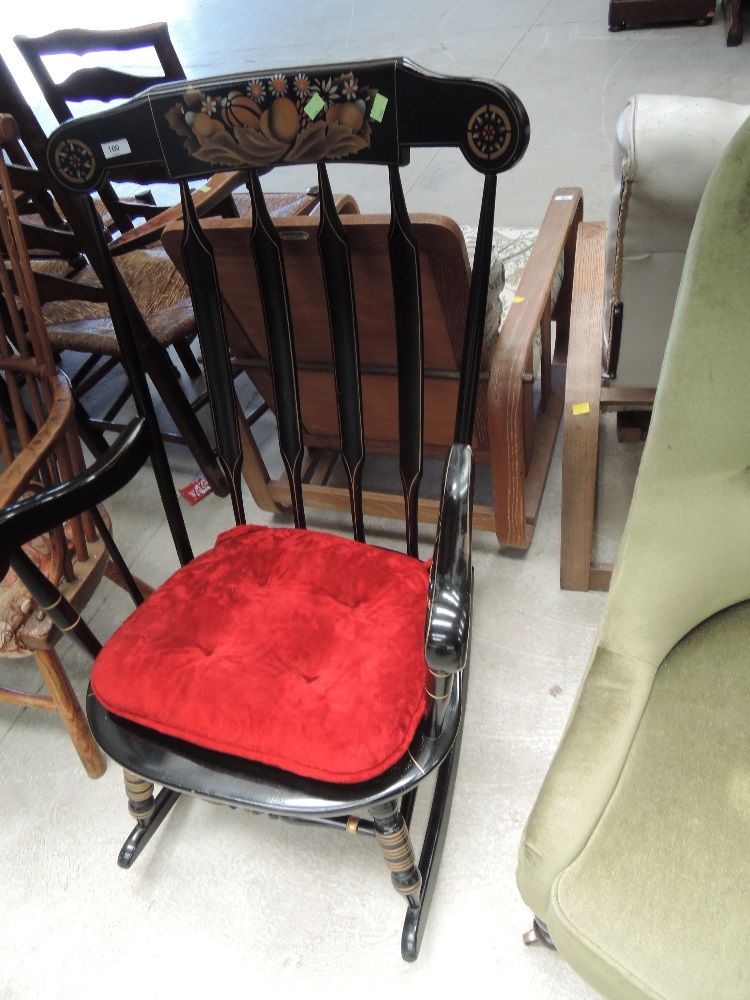 A late 20th century black finish rocking armchair having stencilled detail