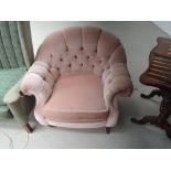 A late 20th Century period style armchair having smokey pink dralon upholstery on mahogany turned