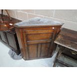 A 19th century oak corner cupboard having panelled door, width approx. 82cm