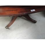 A late 19th century mahogany composite dining table having oval top on bulbous column and