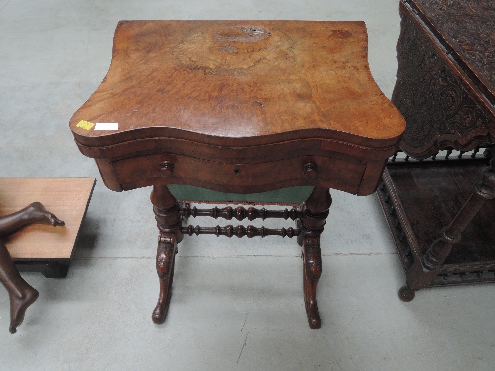 A Victorian burr walnut sewing/games table having swivel top over drawer and casket, on bulbous legs