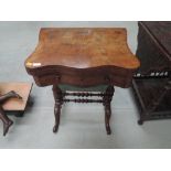 A Victorian burr walnut sewing/games table having swivel top over drawer and casket, on bulbous legs