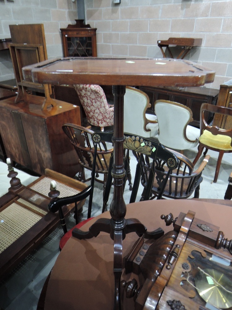 A 19th century mahogany pedestal table having shaped rectangular top on turned column and triple