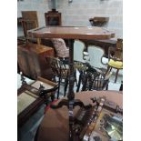 A 19th century mahogany pedestal table having shaped rectangular top on turned column and triple