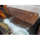 A 19th century mahogany dining table having oval drop leaf top on demi cabriole legs and hoof