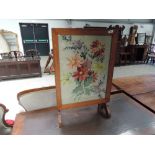 A 1930's golden oak frame firescreen/occasional table having woodwork inset, width approx. 46cm