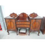 An early 20th century mahogany sideboard in the Chippendale revival style having crest and recess