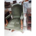 A mid 20th century mahogany frame swivel office armchair having later green upholstery, width