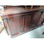 A 19th century flame mahogany sideboard having racked back with triple cupboard under, with half