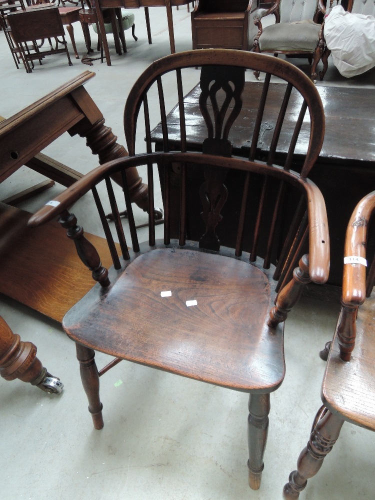 A 19th century yew and elm Windsor armchair having splat and spindle back, with solid seat and