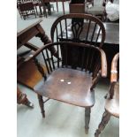 A 19th century yew and elm Windsor armchair having splat and spindle back, with solid seat and