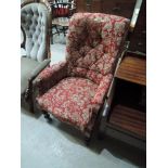 A late 19th century mahogany frame armchair having late red pattern upholstery on turned legs