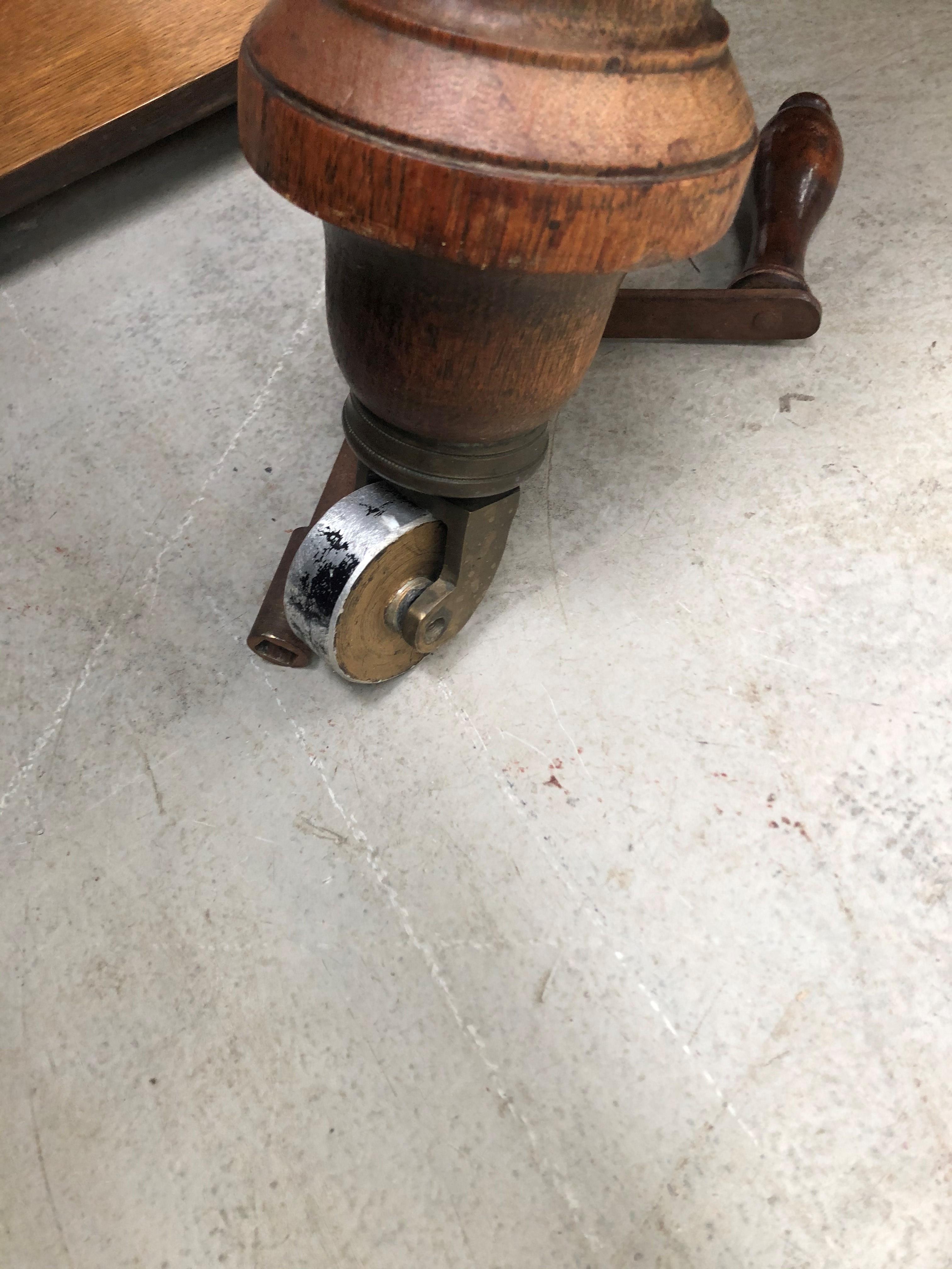 A late Victorian golden oak dining table on heavy turned legs with extra leaf, closed width approx - Image 4 of 4