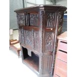 A late 19th century oak credence cupboard having extensive medieval style carved decoration with