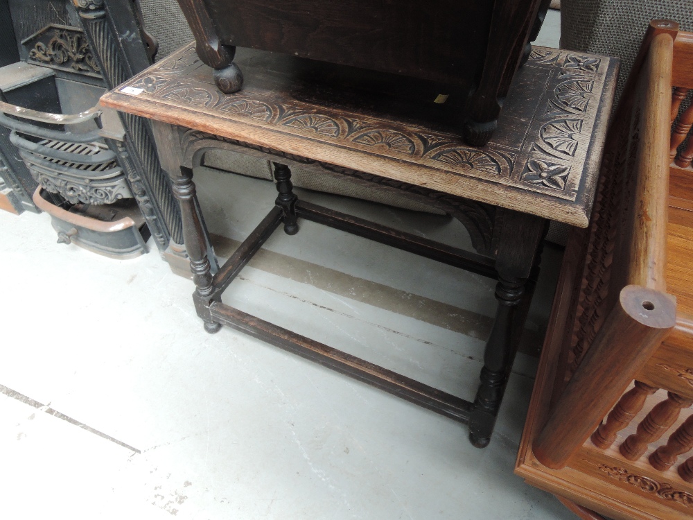 An early 20th Century occasional table having lunette carved rectangular top on baluster legs, width