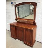A Victorian mahogany sideboard having large mirror back with central drawer and recess cupboard,