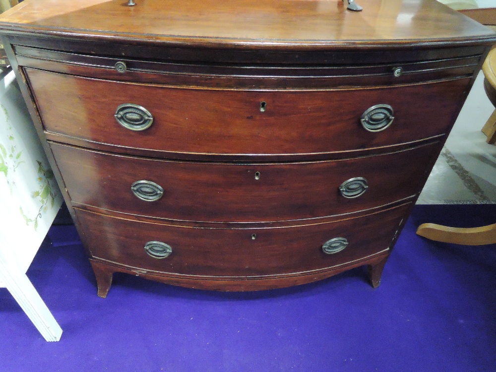 A 19th Century mahogany bow fronted chest of three long drawers, with brushing slide , approx. width