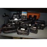 A collection of vintage cameras, binoculars and similar including Praktika, FujiFilm, Golding and