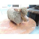 A novelty footstool modelled as highland cow, toe to tail length approx. 70cm height 40cm