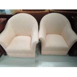 Two modern tub chairs having pink upholstery