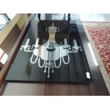 A mirrored wall hanging, depicting chandelier , approx. dimensions 70 x 50cm