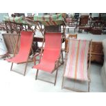 Three vintage deckchairs, including two with canopies