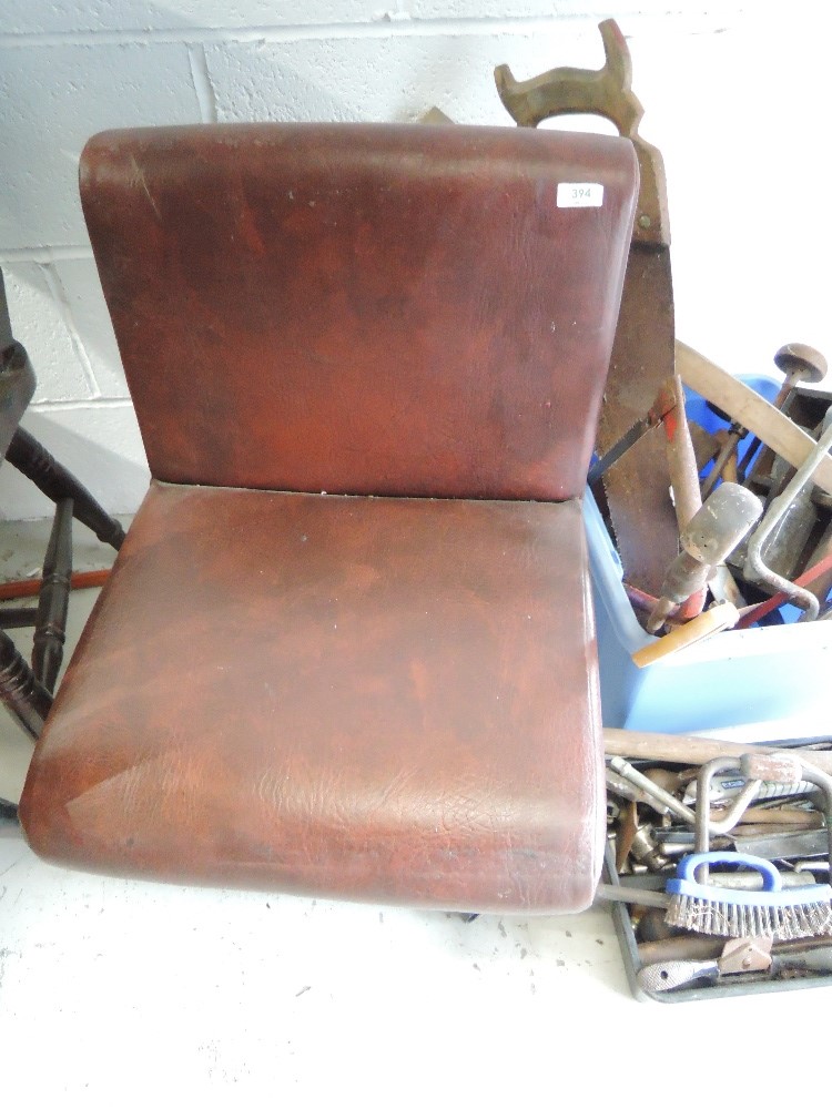 An adapted vinyl chair, with wheeled base