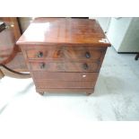 A 19th century mahogany commode formed as small chest of drawers, with lift top and fitted interior,