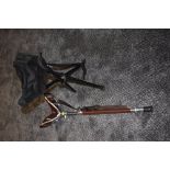 A vintage shooting stick and similar folding stool.