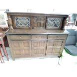 A reproduction court cupboard, in the Ercol style, approx. Width 153cm