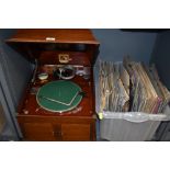 A HMV wooden cased wind up gramophone, model 103, also included are a tin of needles and a box of